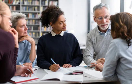 Educators collaborating at a table in a professional development session
