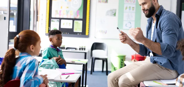 Educator working with students in a classroom