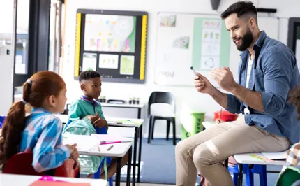 Educator working with students in a classroom